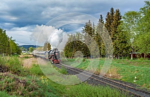 Vintage black steam locomotive train with wagons rush railway