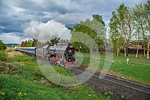 Vintage black steam locomotive train with wagons rush railway