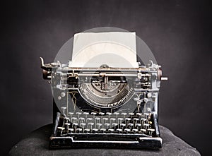 Vintage black typewrite with inserted paper sheet