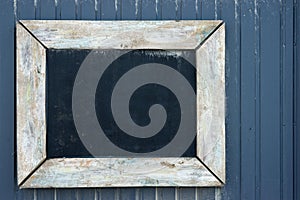 Vintage blackboard on a wooden wall