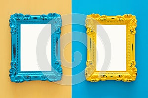 Vintage blank blue and yellow photo frames over double colorful background. Ready for photography montage. Top view from above.