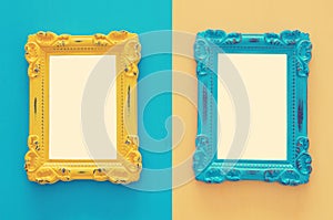 Vintage blank blue and yellow photo frames over double colorful background. Ready for photography montage. Top view from above.