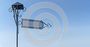 Vintage blank directional road signs against blue sky. White metal arrows on the signpost.