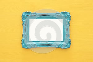 Vintage blank yellow photo frame over gray background. Ready for photography montage
