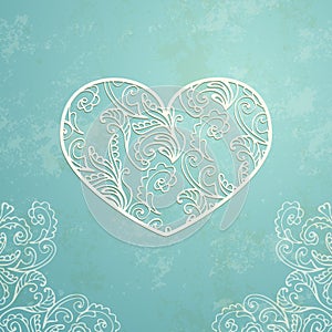 Vintage blue background with old paper texture and abstract ornamental lacy heart.