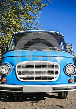 Vintage blue bus. Retro van hippie camper car on sunny street of the city.