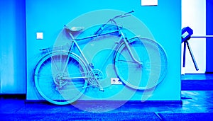 Vintage blue color bicycle on decorative house wall