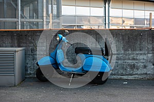 Vintage blue gas powered city scooter moped parked on the streets of Zurich Switzerland