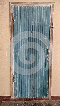 Vintage blue grunge style door with large doorbell button