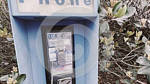 Vintage Blue outdoors public payphone booth side view