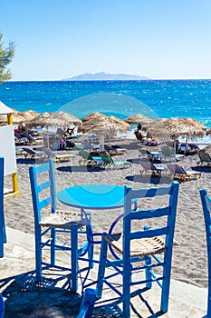 Blue table and two chairs by Black Beach Kamari Santorini Greece
