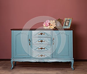 Vintage blue wooden dresser, tender bouquet and two frames.
