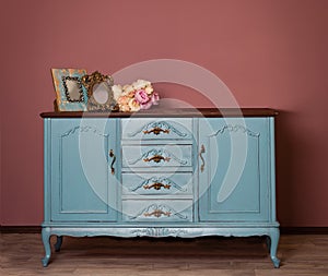 Vintage blue wooden dresser, tender bouquet and two frames.