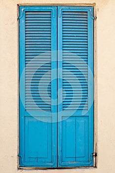 Vintage blue wooden shutters on a window