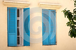 Vintage blue wooden shutters on a windows