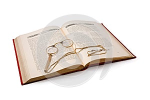 Vintage book and pince-nez. Isolated on white. photo