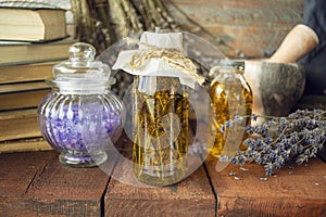 Vintage books, dried lavender flowers and bottles of essential oil