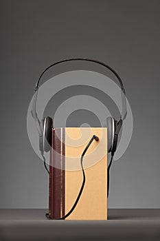 Vintage books on grey background with a Headphone, concept for A