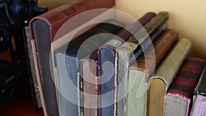 Vintage books. View of row of old books and vintage typewriter