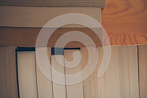 Vintage books on wooden background. Close up view of books background for design. Old books on a shelf.