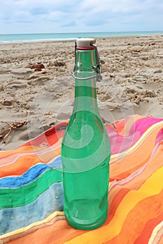 Vintage bottle with liquid lon blankets on a warm summer day