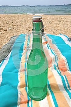 Vintage bottle with liquid lon blankets on a warm summer day