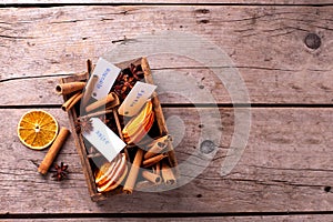 Vintage box with  different spices - cinnamone, slices of dried orange, anise on vintage wooden  background. photo