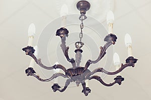 Vintage bras chandelier with economical bulbs photo