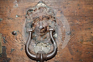 Vintage brass door knocker on an old door, Italy, Rome