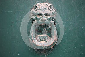 Vintage brass door knocker on an old door, Italy, Rome