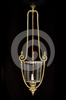 Vintage brass hanging light isolated on black background