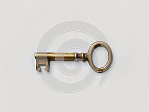 Vintage brass key on plain background photo