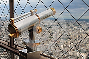 Vintage brass telescope overlooking Paris