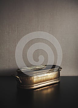 Vintage brazen metal bowl on dark background