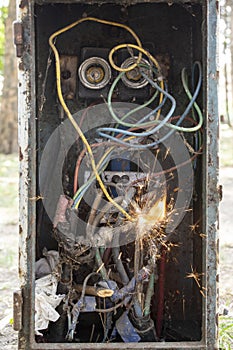 Vintage breaker box with dirty wires, sparks and flame, short circuit