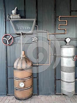 Vintage brewing equipment on a gray wall