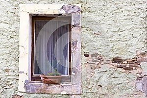 vintage brick wall background with old windowold window with flowers on a stone wall