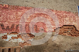 Vintage brick wall with painted ghost signs and deterioration