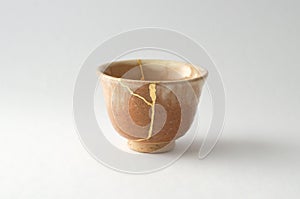 Vintage broken Japanese cup repaired with gold kintsugi technique