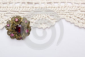 Vintage brooch on lace background