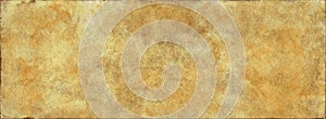 Vintage brown paper background old grunge yellowed parchment texture with aged stained pattern and rough edges in abstract banner
