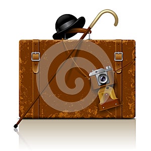Vintage brown threadbare suitcase with walking stick, bowler hat
