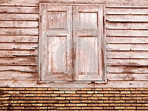 Vintage brown unique ancient wooden window and old crack brick wall retro style in rural for background