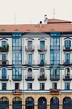 Vintage buildings with vivid blue windows, balconies and shutters in old-fashioned architectural style. Vertical photo