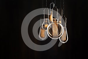 Vintage bulbs on black background - idea, innovation, teamwork and leadership concept. Space for text