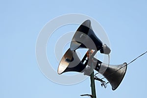 Vintage bullhorn or megaphone, loudspeaker outdoor on the sky background, concept, public relations sound, notify news, warning