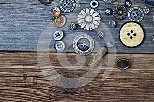 Vintage buttons on the old wooden surface