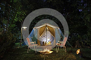 vintage cabin tent,  Antique oil lamp, retro chairs, Group of camping tents with outdoor coffee-making facilities on wooden tables