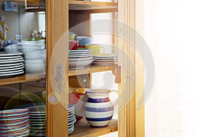 Vintage cabinet with colorful bowls and plates