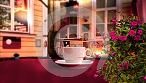 Vintage cafe cup of coffee and flowers on wooden table  top old wooden house and sun light reflection  in windows